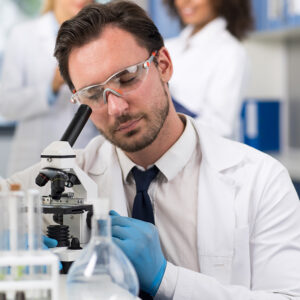 male doctor testing with microscope